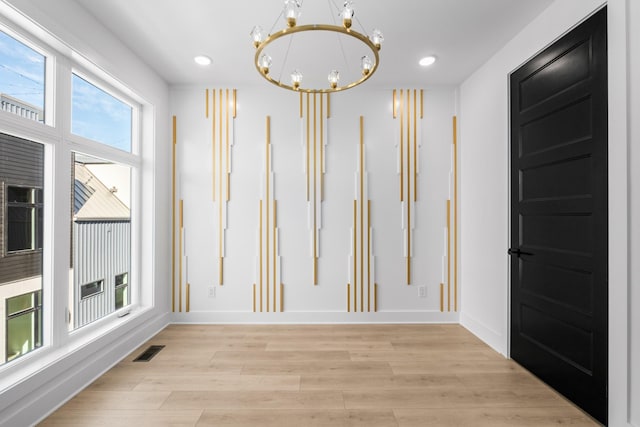 interior space featuring a chandelier and light hardwood / wood-style floors