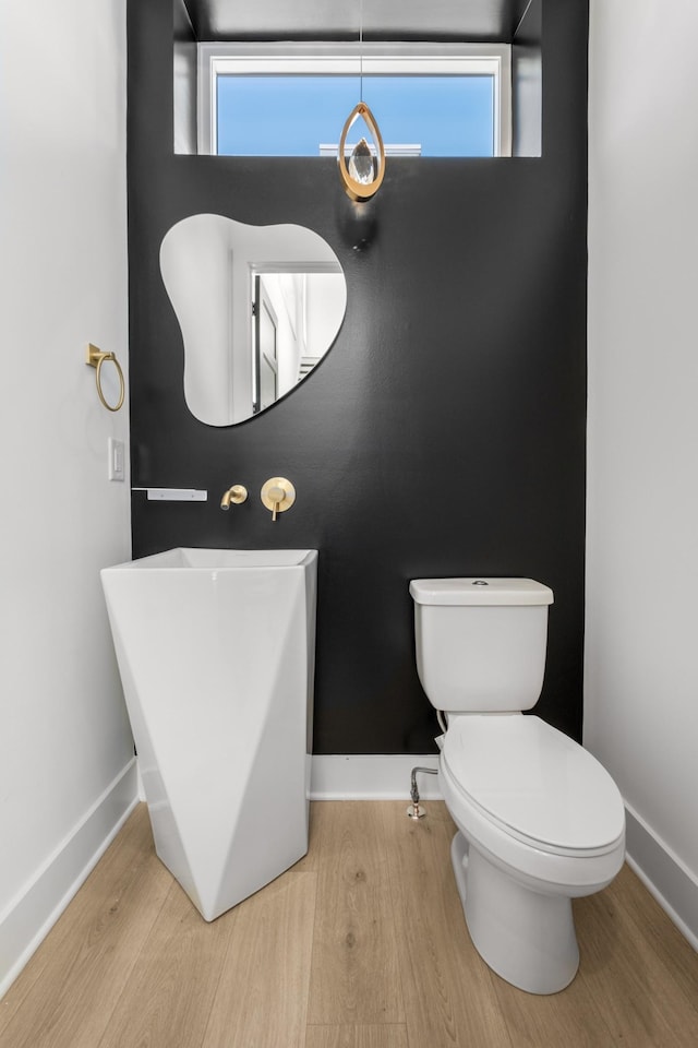 bathroom featuring hardwood / wood-style floors and toilet