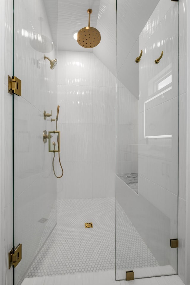 bathroom with lofted ceiling and an enclosed shower