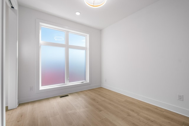 spare room with light hardwood / wood-style flooring