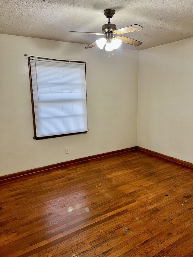 unfurnished room featuring dark hardwood / wood-style floors, a textured ceiling, and ceiling fan