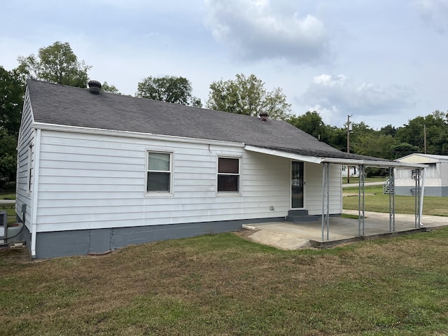 rear view of property featuring a patio and a lawn