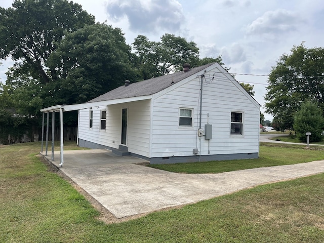 view of home's exterior featuring a carport and a lawn