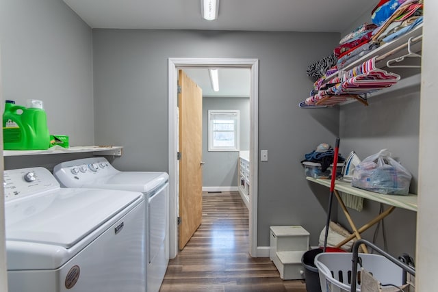 laundry room with dark wood-type flooring and washing machine and dryer