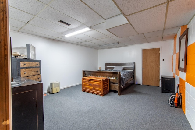 carpeted bedroom with a drop ceiling