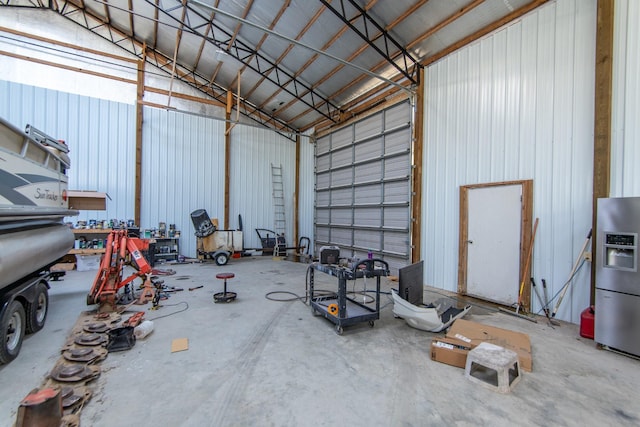 garage with stainless steel fridge with ice dispenser