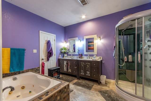 bathroom with vanity and shower with separate bathtub