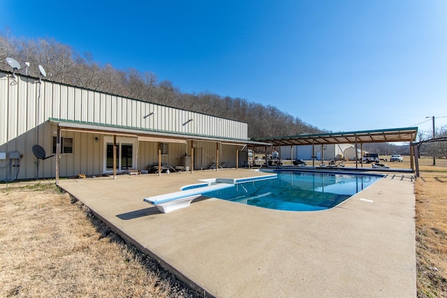 view of pool featuring a patio and a diving board