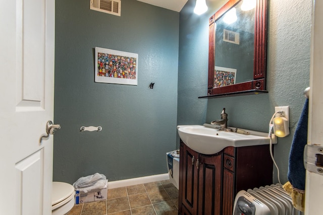 bathroom with vanity, toilet, and tile patterned flooring