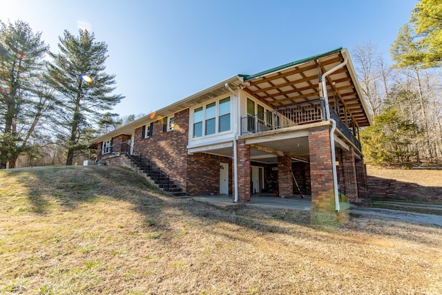 exterior space with a patio and a lawn