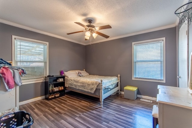 bedroom featuring ornamental molding, dark wood-type flooring, and a textured ceiling