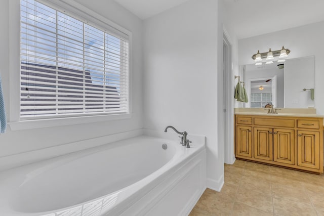 bathroom with tile patterned flooring, vanity, and a bathing tub