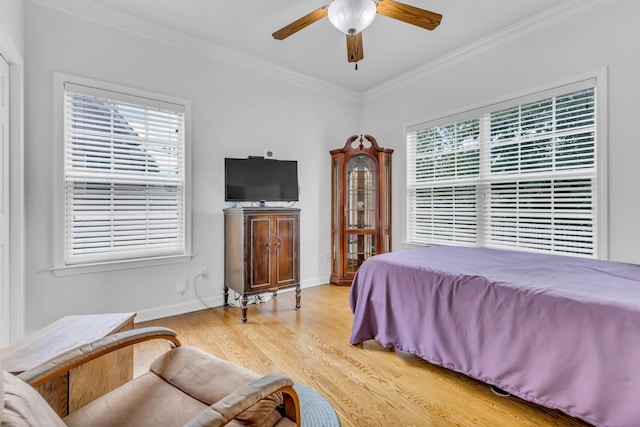 bedroom with ceiling fan, ornamental molding, and light wood-type flooring