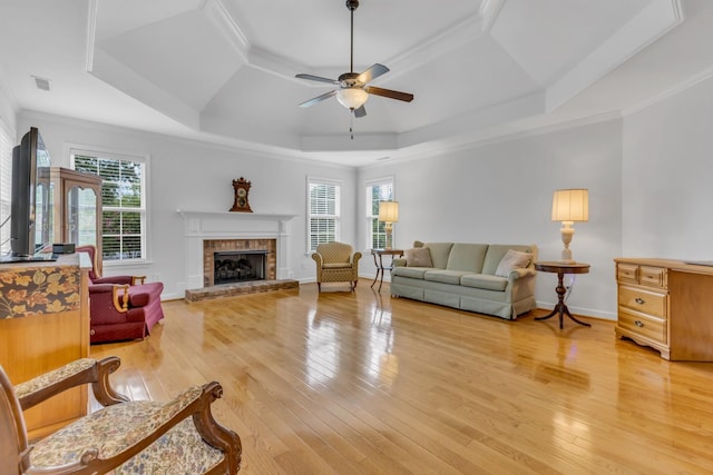 living room featuring hardwood / wood-style floors, plenty of natural light, and a raised ceiling