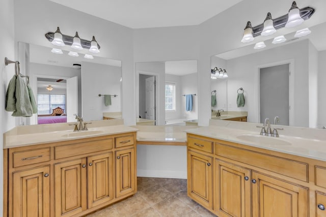 bathroom featuring tile patterned flooring, vanity, and plenty of natural light