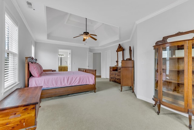 carpeted bedroom featuring crown molding, ceiling fan, connected bathroom, and a raised ceiling