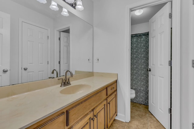 bathroom featuring tile patterned flooring, vanity, and toilet