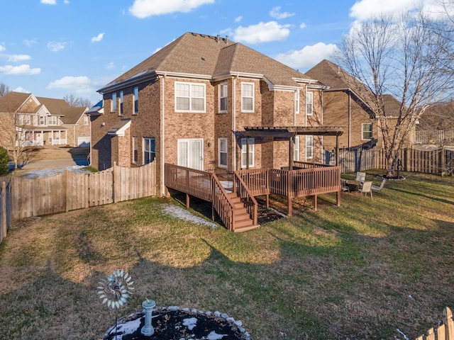 rear view of property with a pergola, a lawn, and a deck