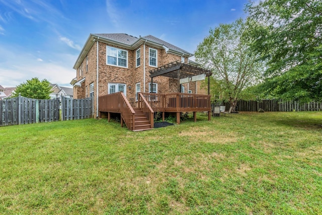 back of property with a lawn, a deck, and a pergola