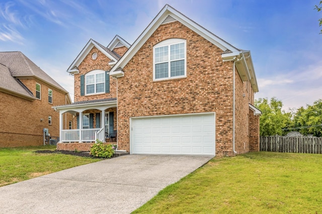 view of front property with a garage, covered porch, and a front lawn