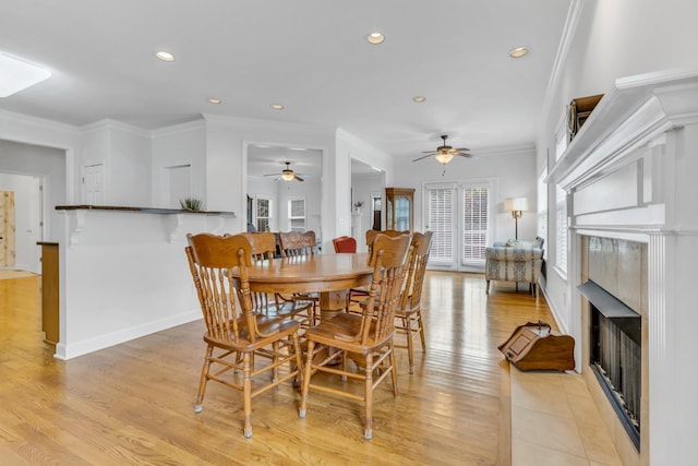 dining room with crown molding and light hardwood / wood-style floors