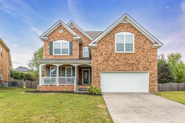 view of front of house with a garage, a porch, cooling unit, and a front lawn