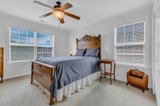 carpeted bedroom featuring crown molding and ceiling fan