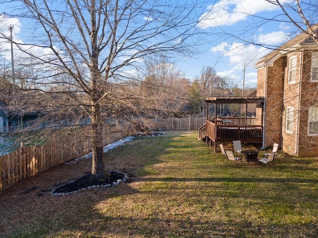 view of yard featuring a deck and an outdoor fire pit