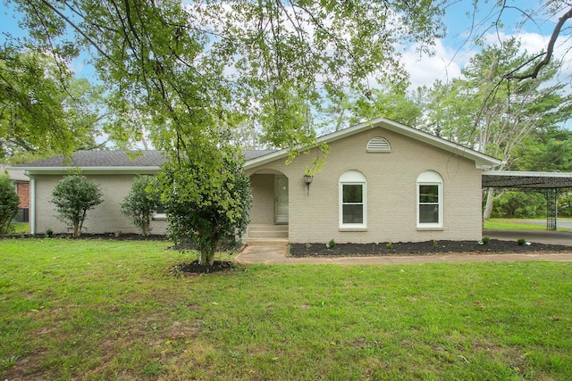 ranch-style home featuring a front yard and a carport