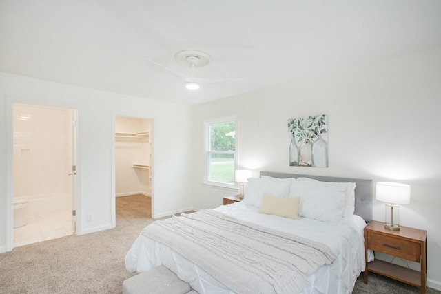 bedroom featuring a closet, carpet flooring, ensuite bath, and a spacious closet