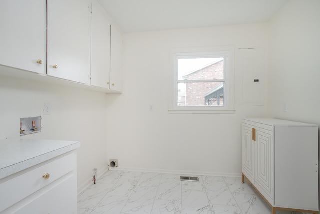 clothes washing area with cabinets, gas dryer hookup, and washer hookup