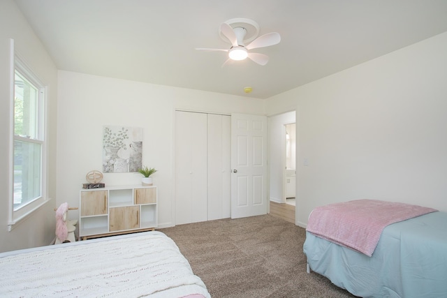 carpeted bedroom with ceiling fan and a closet