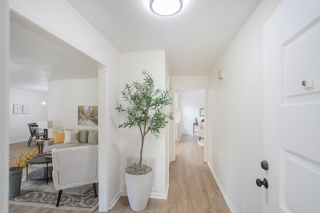 hall with light hardwood / wood-style flooring