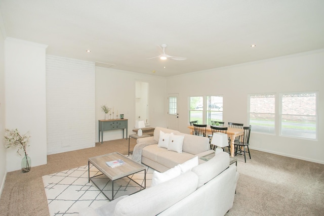 living room with crown molding, light colored carpet, and ceiling fan