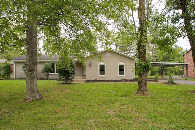 ranch-style house featuring a carport and a front lawn