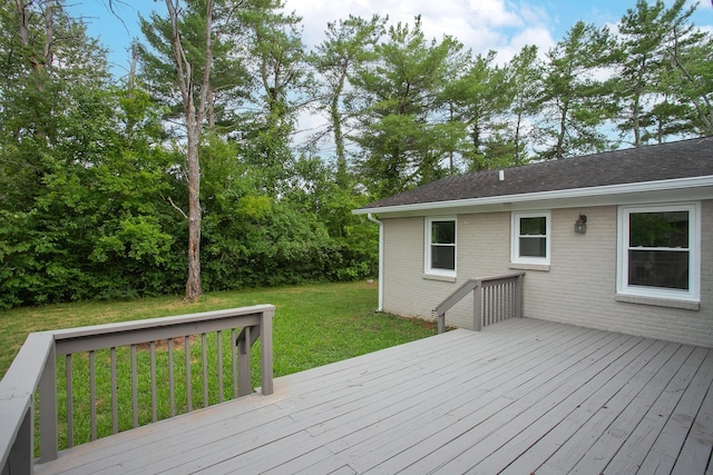 wooden deck featuring a yard