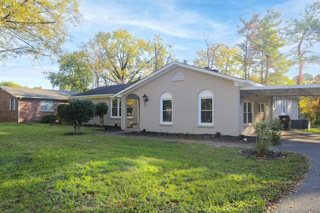 view of side of home featuring a carport and a yard