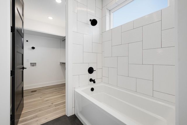 bathroom featuring hardwood / wood-style flooring and tiled shower / bath combo