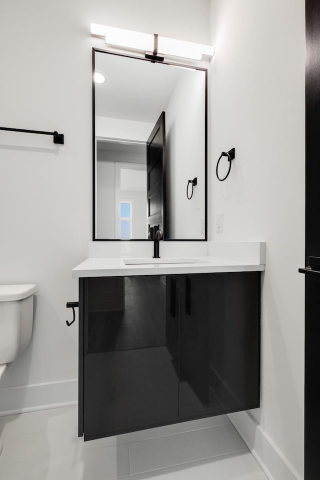 bathroom featuring vanity and toilet