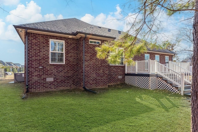 back of house featuring a wooden deck, central air condition unit, and a lawn