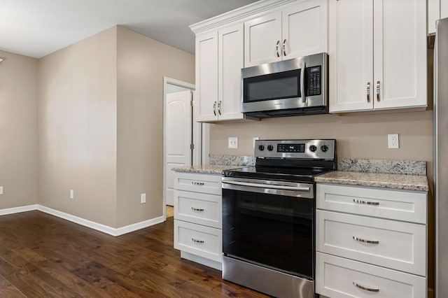 kitchen with white cabinetry, dark wood-type flooring, light stone countertops, and appliances with stainless steel finishes