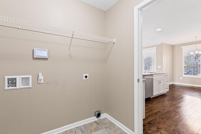 laundry room featuring hookup for a washing machine, electric dryer hookup, hardwood / wood-style flooring, and an inviting chandelier