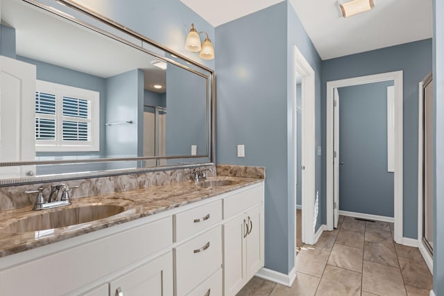 bathroom featuring an enclosed shower, vanity, and tile patterned floors