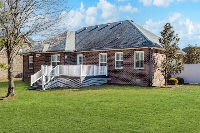 back of property with a wooden deck and a yard