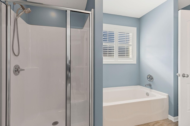 bathroom featuring tile patterned floors and shower with separate bathtub