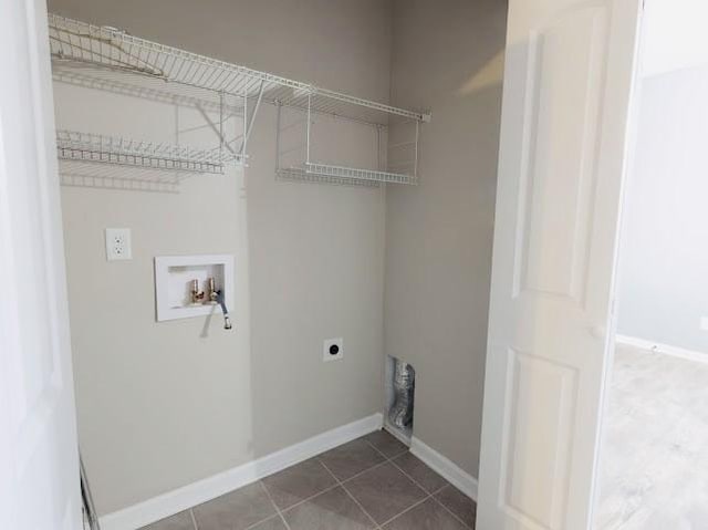 laundry area featuring electric dryer hookup, washer hookup, and tile patterned floors