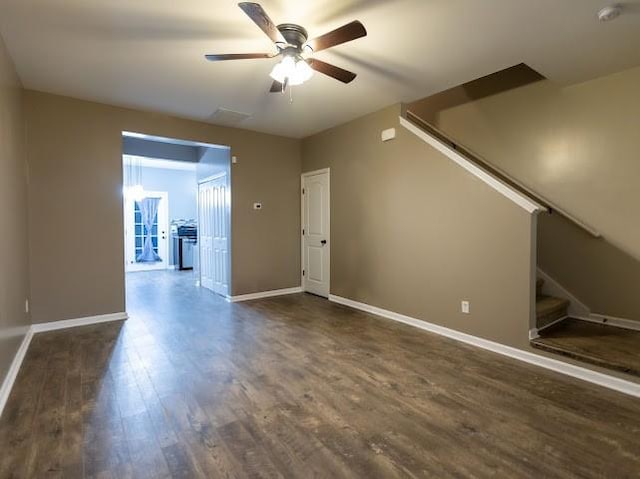 empty room featuring dark wood-type flooring and ceiling fan