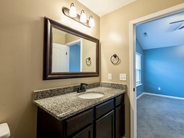 bathroom featuring vanity and lofted ceiling