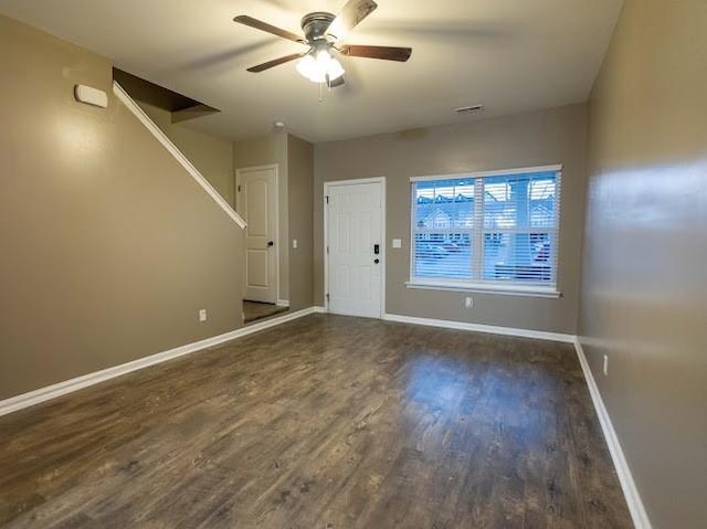 unfurnished room with ceiling fan and dark hardwood / wood-style flooring