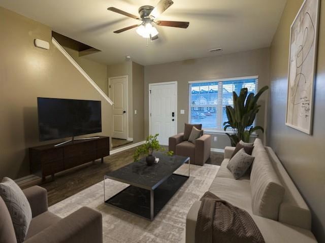 living room with ceiling fan and light wood-type flooring